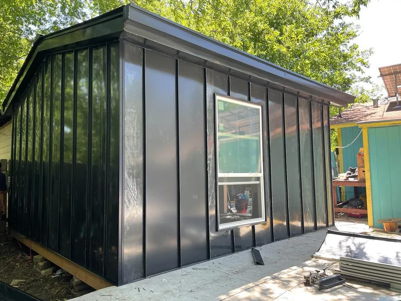 Black standing seam metal wall panels for Roof Inspection in Town and Country